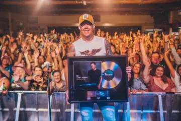 Casey Barnes holding his first Gold record