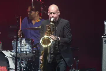 Andy Bickers on stage with Cold Chisel in 2024