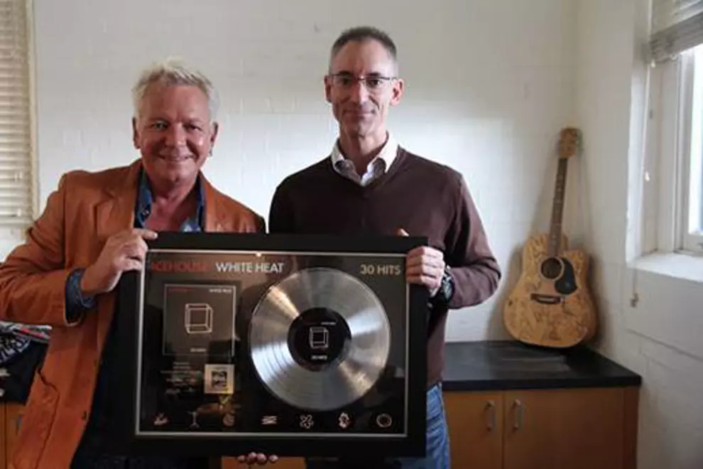 A national treasure, and his platinum record (with Universal's George Ash, right)