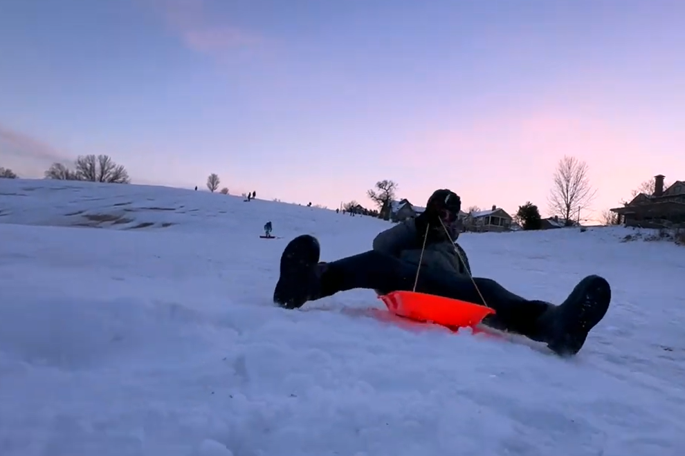 Jordie Lane sledding through snow