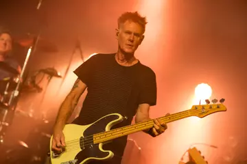 Hillman performing with Midnight Oil in Thirroul last year. Pic by Peter Dovgan.