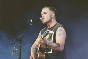New Zach Bryan Song Sparks Backlash Over ICE Raids And Patriotism