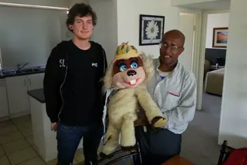 Two men and a puppet.