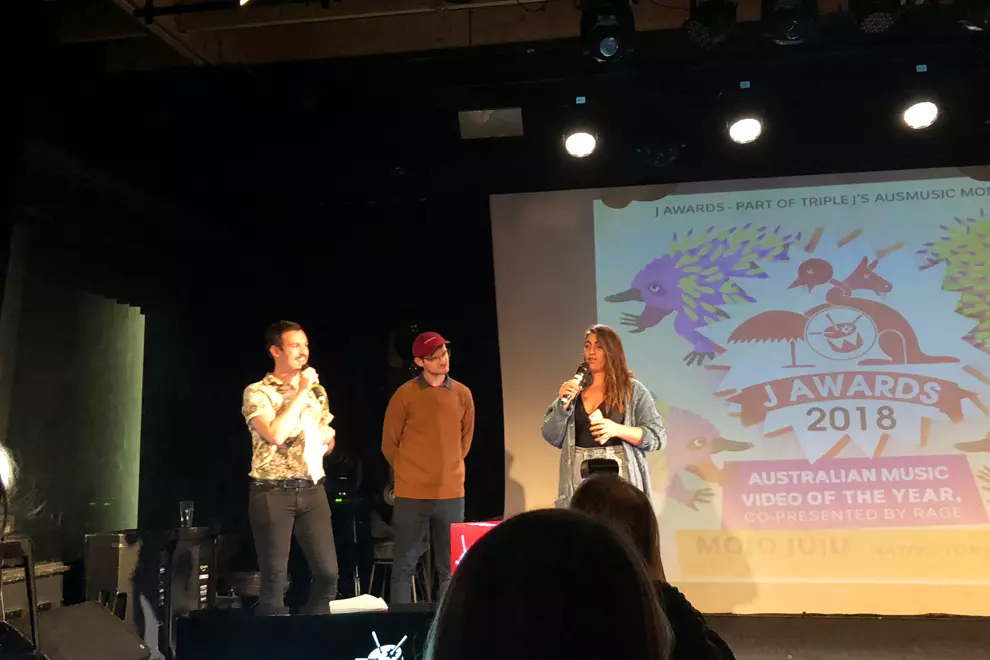 Claudia Sangiorgi Dalimore accepting the award from triple's Ben & Liam