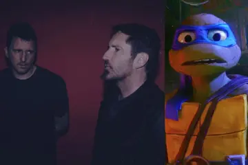 Photo of Trent Reznor, Atticus Ross, and Leonardo the Teenage Mutant Ninja Turtle