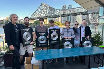 Shag Rock holding Platinum plaques