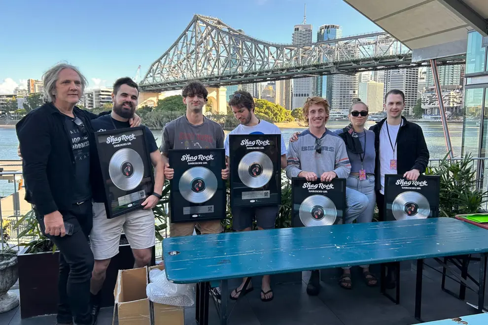 Shag Rock holding Platinum plaques