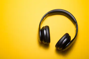 Wireless headphones on yellow background
