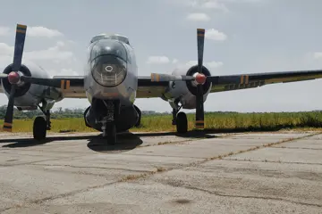 Grey twin engine bomber plane on tarmac