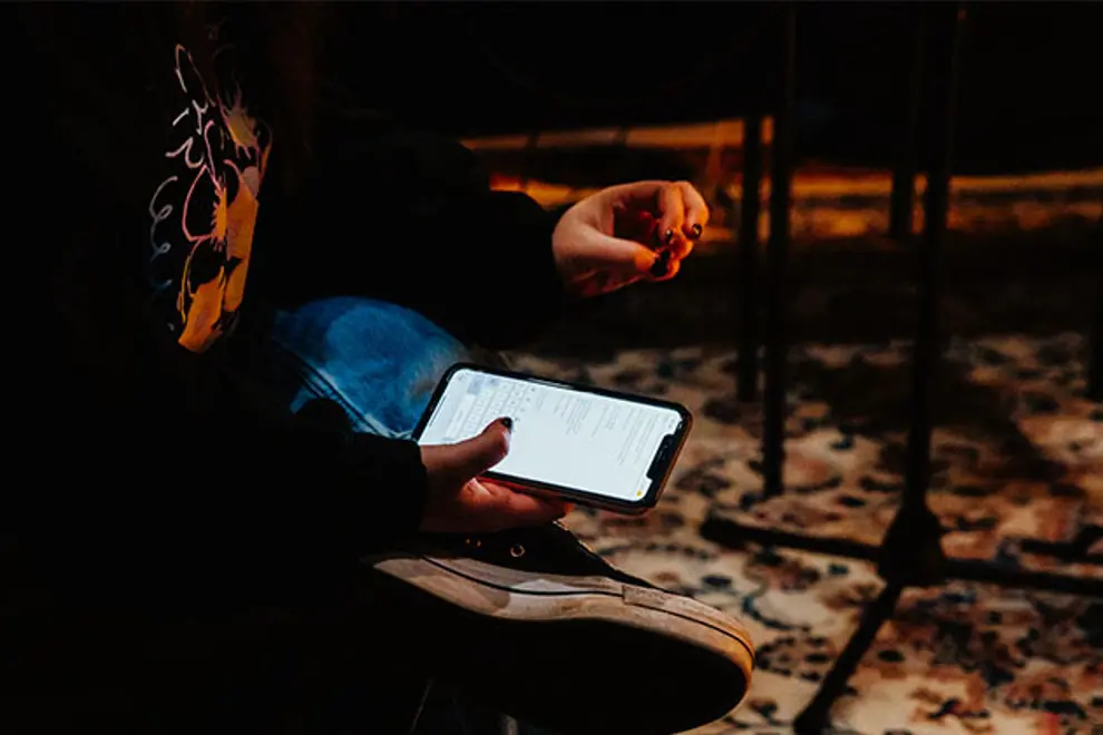 Person scrolling on their phone